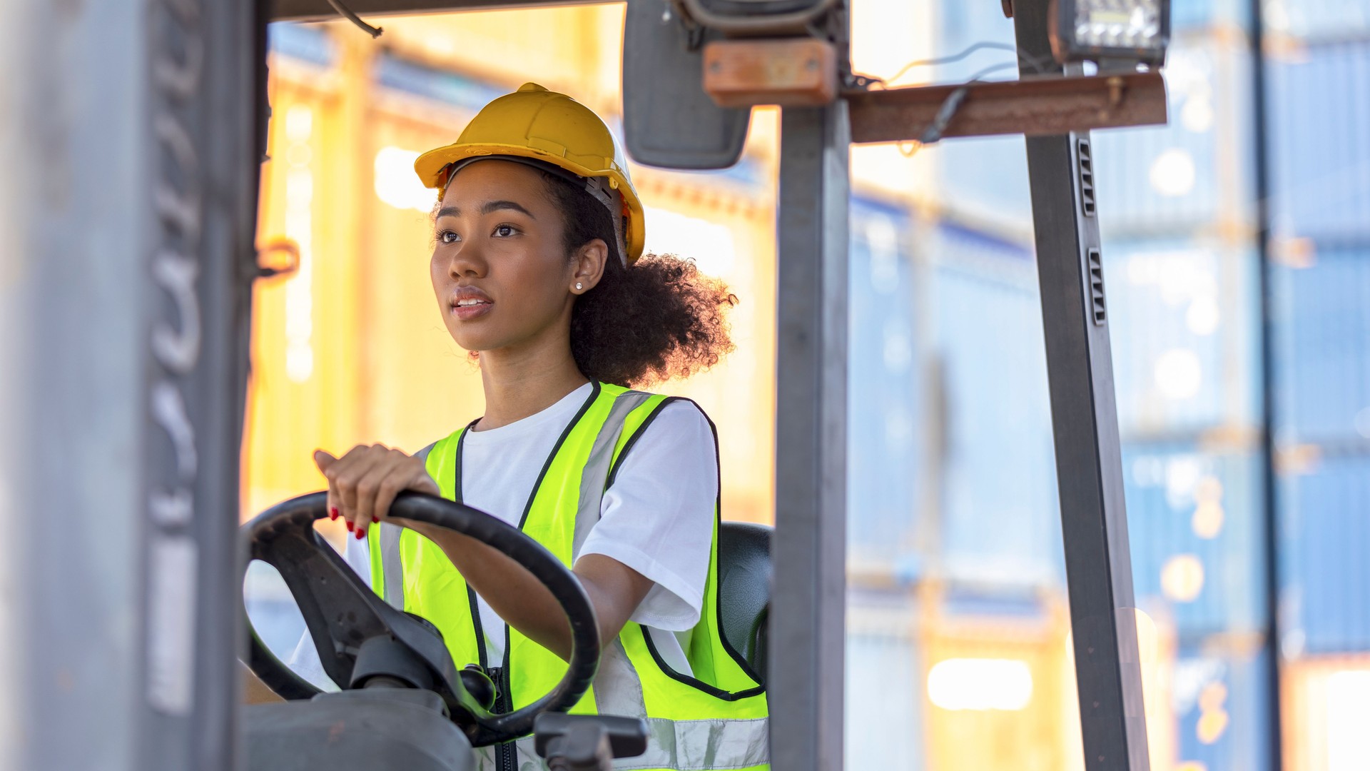 Young African American mechanical engineer with forklift